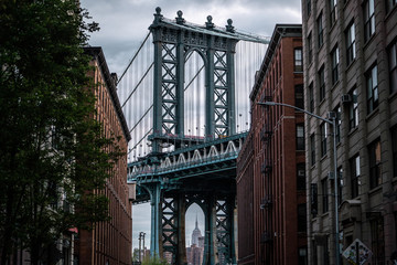 Fototapeta na wymiar View of one of the towers of the Manhattan Bridge from the streets of the DUMBO district, Brooklyn, NYC 