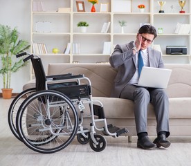 Dsabled businessman on wheelchair working home