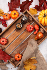 Wooden box with pumpkins and autumn leaves. Autumn menu in the restaurant. View from above. Copy space.
