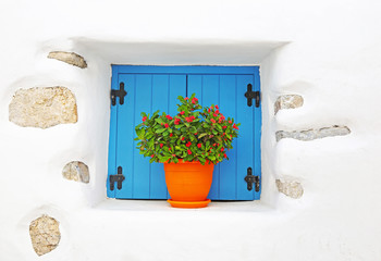 traditional white house with turquoise window and blooming flowers at Koufonisia islands Cyclades Greece