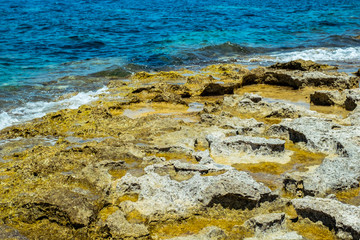 blue water on the rocky shore