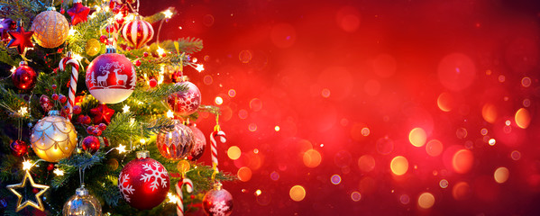 Christmas Tree With Ornament And Bokeh Lights In Red Background