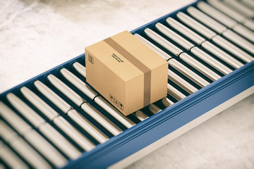 Cardboard boxes on conveyor rollers ready to be shipped by courier for distribution