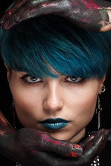 Portrait of beautiful girl with short blue fashionable hairstyle and blue lipstick on a dark...