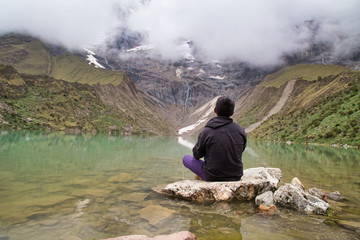 Fototapeta na wymiar man in front of the Humantay Lake on the Salkantay Trail, the trek to Machu Picchu, Peru