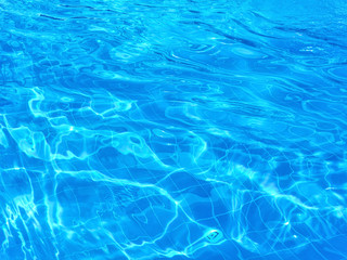 Ripples appeared on the surface of the water in the pool. The pattern on the bottom of the pool is distorted due to water