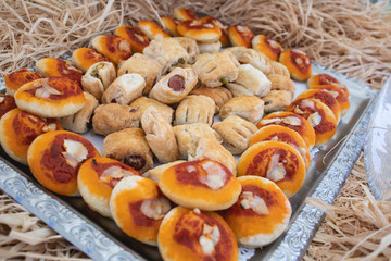 tray with small pizzas with tomato and mozzarella, rustic with wurstel
