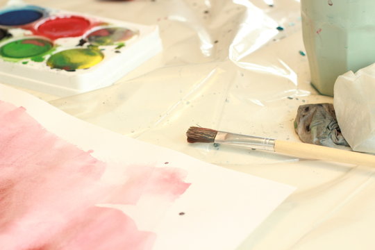 Creative paintings diy watercolor. Aquarelle artwork colors on paper. Dirty paint tools and brusches.