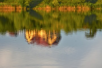 the image of a house mirrored in water