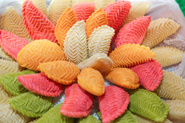 National Azerbaijan sweet pastry Colorfull shekerbura with nuts and honey on wooden table background, close up. Delicious dessert Colorfull Shekerbura baked during the spring holiday Novruz.
