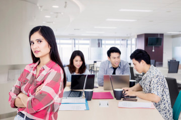 Confident woman with her business team in office