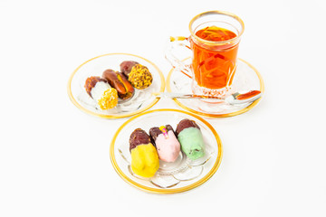 tea with saffron, sweet dates on crystal plates, golden design, chocolate bites