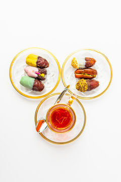 tea with saffron, sweet dates on crystal plates, golden design, chocolate bites