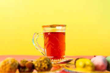 tea with saffron, sweet dates on crystal plates, golden design, chocolate bites