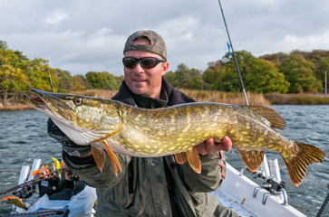Huge pike trophy and happy angler