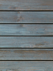Blue wooden background with detailed wood structure with knots and nail holes. Dark wood texture background surface with old natural pattern