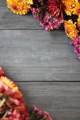 Beautiful flowers on wooden table. Autumn background.