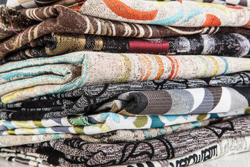 Stacked pile of different and colorful textile materials