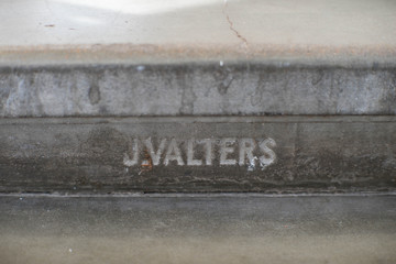 The sign on concrete. J. Valters - latvian artist.