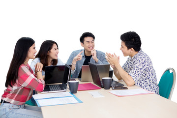 Happy young employees brainstorming on studio