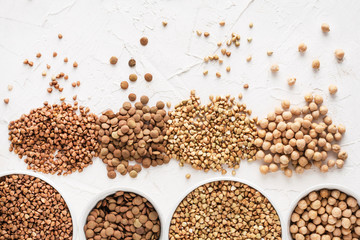 buckwheat green and ordinary lentils chickpeas on a white background top view different types of cereals vegan food