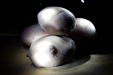 Potato in the light of flashlights from different sides
