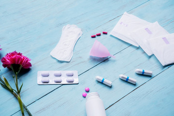 Pain relief pills with pads, tampons, and cup