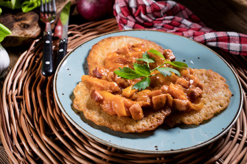Homemade potato pancakes with goulash.