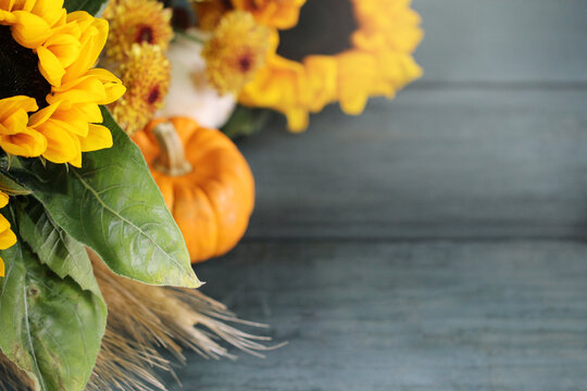 Autumn background with beautiful sunflowers and pumpkins.