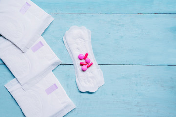Sanitary pads with pills medicine on the table