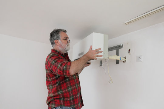 Worker installing air condition equipment