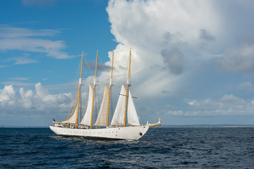 Fototapeta na wymiar Sailing ship with four white sails