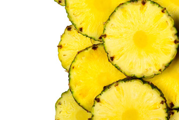 Pineapple juicy yellow slices background. Top view.