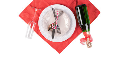 Christmas table setting. Red decoration and candles with Santa hat