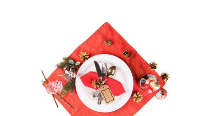 Christmas table setting. Red decoration and candles with Santa hat