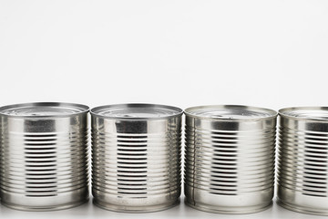 Group of silver canned food on white background.