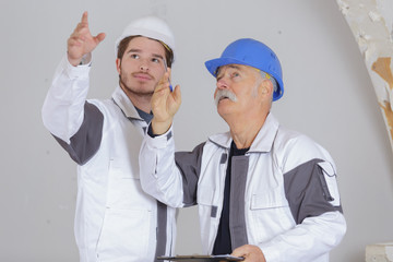 modern building and workers pointing at problem