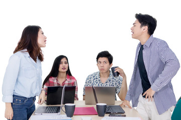 Two young workers quarreling at meeting
