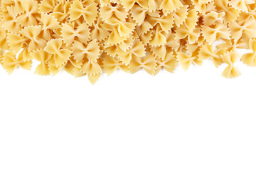 Variety of types and shapes of Italian pasta. Dry pasta background. A portion of Farfalle bows pasta isolated on white . Heap of bow tie pasta isolated on white background.