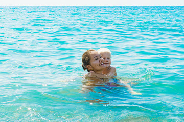 Happy mother and son swimming in the ocean or sea. family concept. Mother day. 