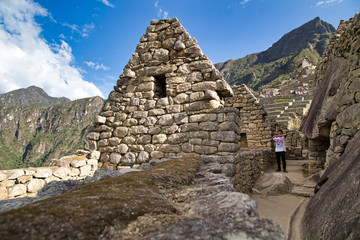 Fototapeta na wymiar Traveller at the Lost city of the Incas, Machu Picchu,Peru on top of the mountain, with the view panoramic