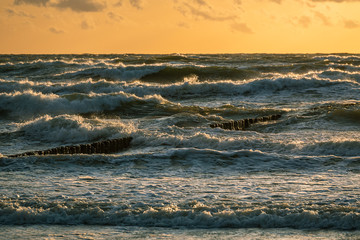 Beautiful voluminous stormy sea at sunset.