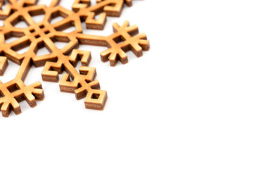 Decor made from natural wood. Isolated on white background. Closeup. Place for text, copy space. Winter, Christmas, New Year greeting card. Wooden decoration - white snowflake, star. Top view