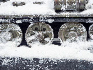 The wheels of the tank on the snow