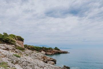 Fototapeta na wymiar Clear amazing azure coloured sea water with granite rocks and grenery.