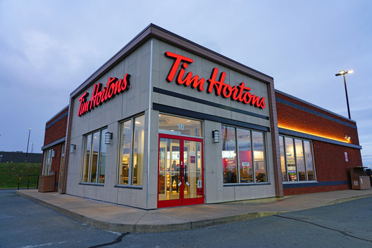 MONTREAL, CANADA - NOVEMBER 6, 2018: Tim Hortons Logo In Front Of One Of  Their Restaurants In Quebec With Their Slogan In French In The Background. Tim  Hortons Is A Cafe And