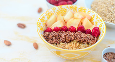 healthy breakfast oatmeal with fruits, raspberries, peach, flax seeds, nuts, good morning concept, healthy food, healthy breakfast
