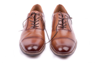 Classic leather elegant shoe on a white background. Beautiful brown luxury and casual leather men shoes. Fashion accessory. Closeup, front view.Both leg. Isolated. 