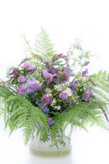 Composition of natural meadow flowers in the vase. Pink clover is used for medical needs. Green fern. Great for bio, eco concepts. Beautiful natural flowers of European meadows in summer