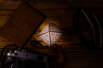Hipster hat, vintage camera, sunglasses, souvenir pyramid and passport on a wooden background. Travel to Egypt. Top view